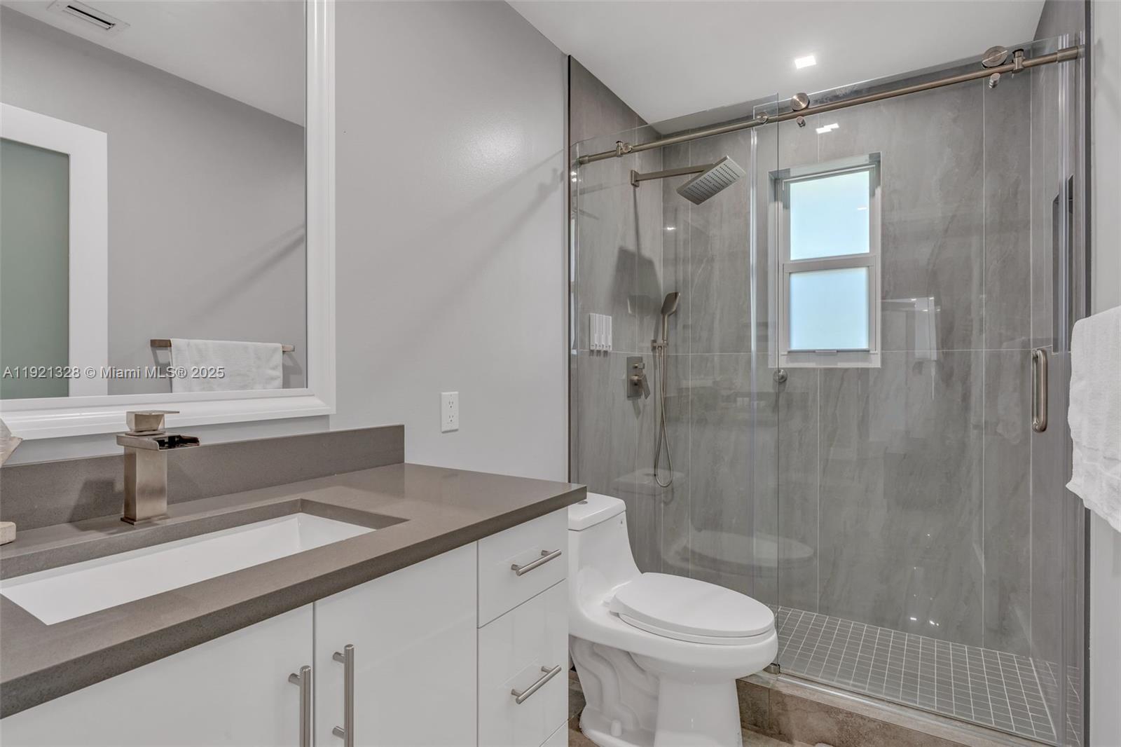 222 2nd Road Key Largo, FL 33037 - Photo 14 of 43 a bathroom with a sink toilet and shower