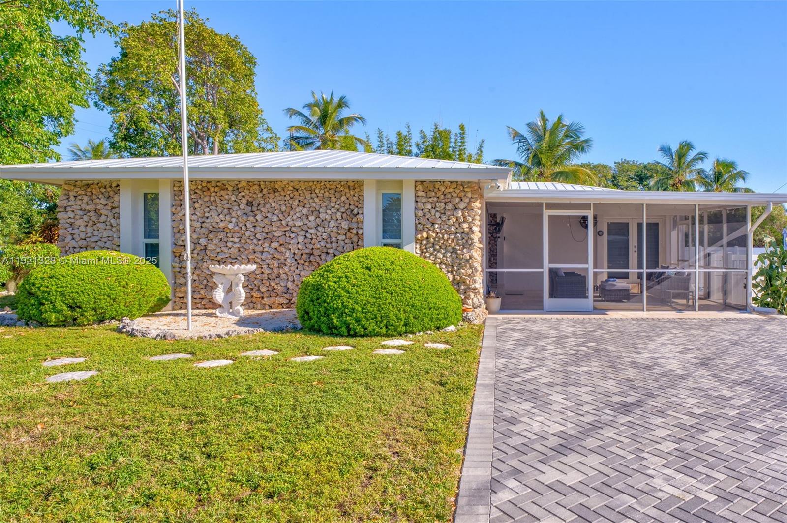 222 2nd Road Key Largo, FL 33037 - Photo 2 of 43 a view of a house with a yard and potted plants