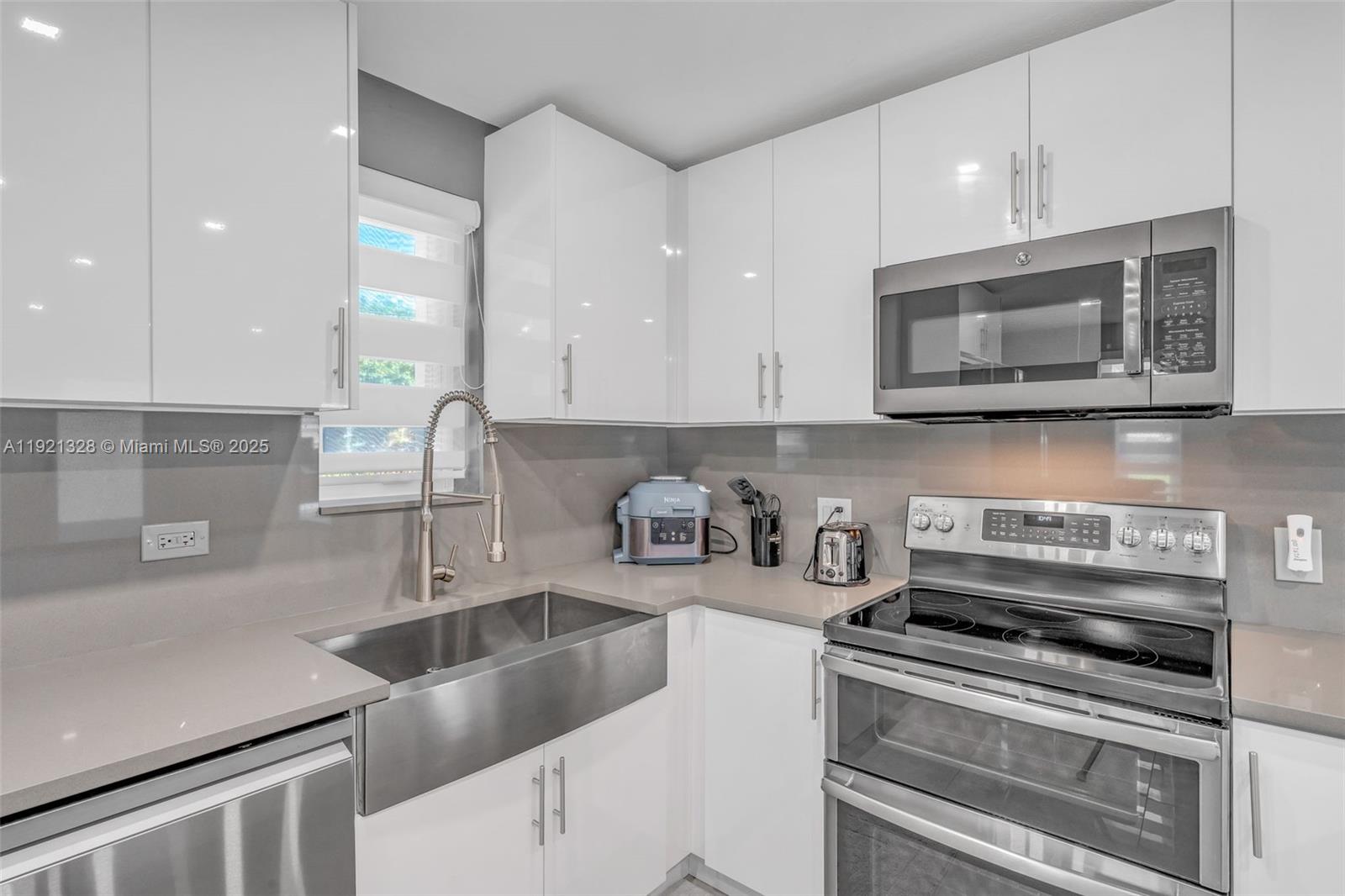 222 2nd Road Key Largo, FL 33037 - Photo 9 of 43 a kitchen with sink a microwave and cabinets