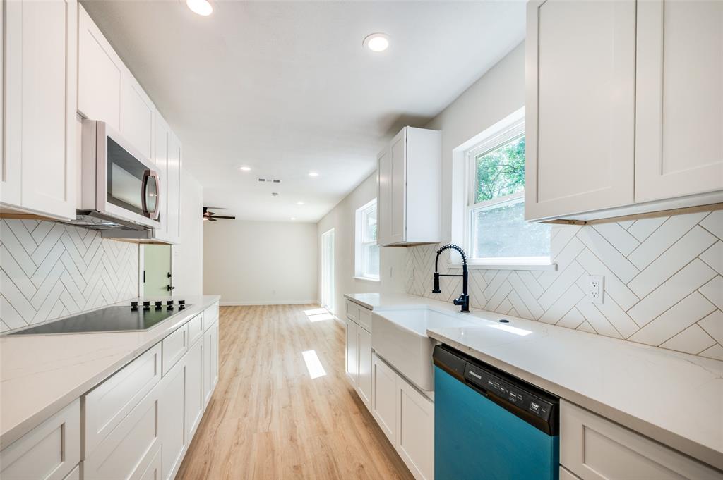 509 Steeple Ridge Court Everman, TX 76140 - Photo 1 of 21 Kitchen with tasteful backsplash, recessed lighting, light wood-type flooring, dishwashing machine, and white cabinetry