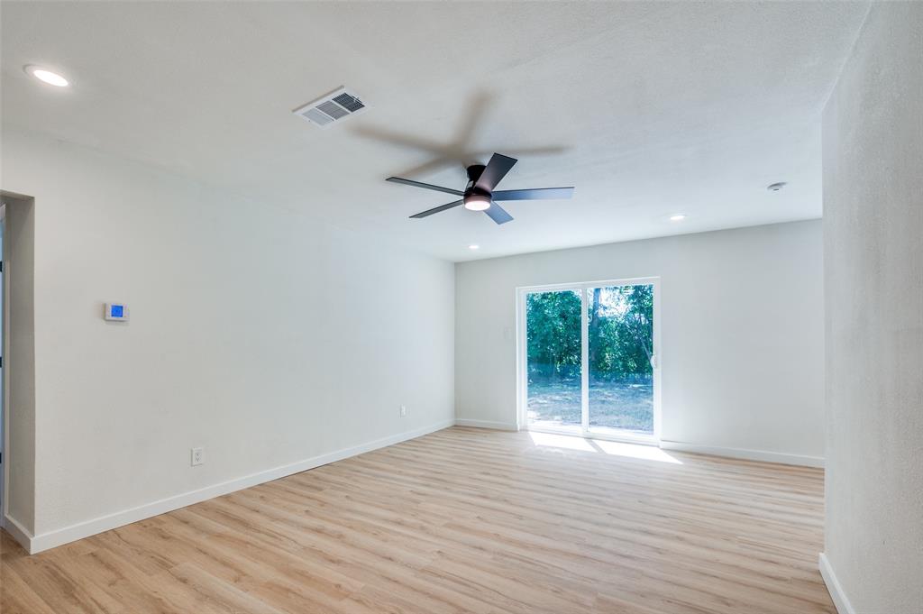 509 Steeple Ridge Court Everman, TX 76140 - Photo 14 of 21 Unfurnished room featuring light wood-type flooring, ceiling fan, and recessed lighting