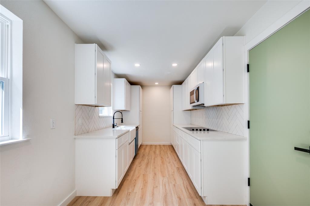 509 Steeple Ridge Court Everman, TX 76140 - Photo 3 of 21 Kitchen with backsplash, light wood-style flooring, white cabinets, light countertops, and recessed lighting