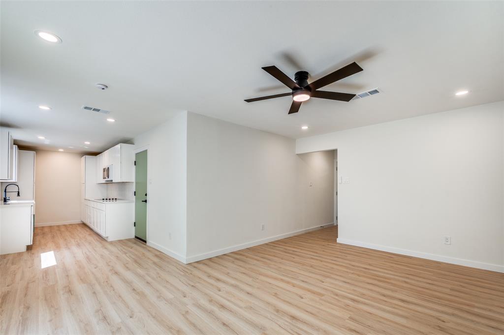 509 Steeple Ridge Court Everman, TX 76140 - Photo 4 of 21 Unfurnished living room featuring a ceiling fan, recessed lighting, and light wood-style floors