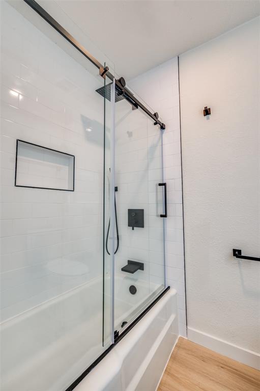 509 Steeple Ridge Court Everman, TX 76140 - Photo 8 of 21 Bathroom featuring bath / shower combo with glass door and wood finished floors