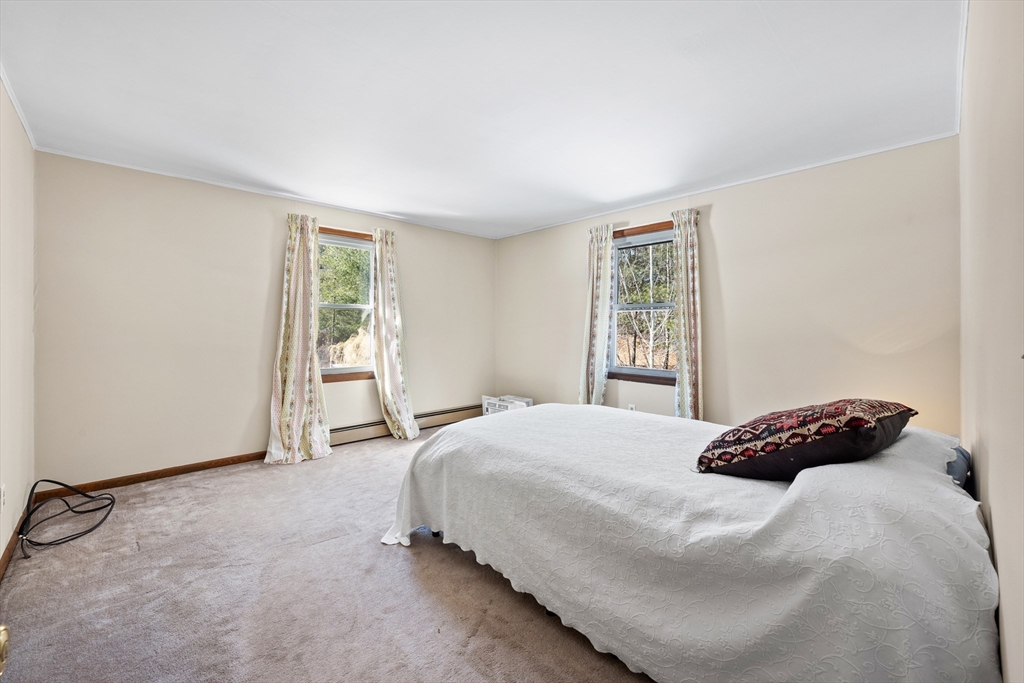 76 Beaver Lake Road Ware, MA 01082 - Photo 13 of 23 a bedroom with a bed and a window