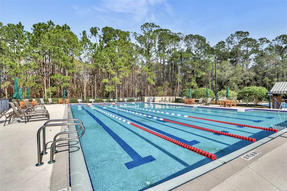 3844 Paddington Place St. Augustine, FL 32092 - Photo 23 of 40 a view of swimming pool with a lounge chair and trees in the background