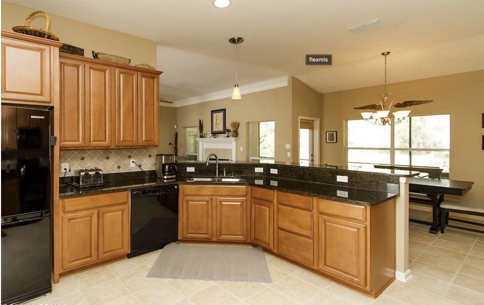 3844 Paddington Place St. Augustine, FL 32092 - Photo 6 of 40 a large kitchen with granite countertop a sink and cabinets