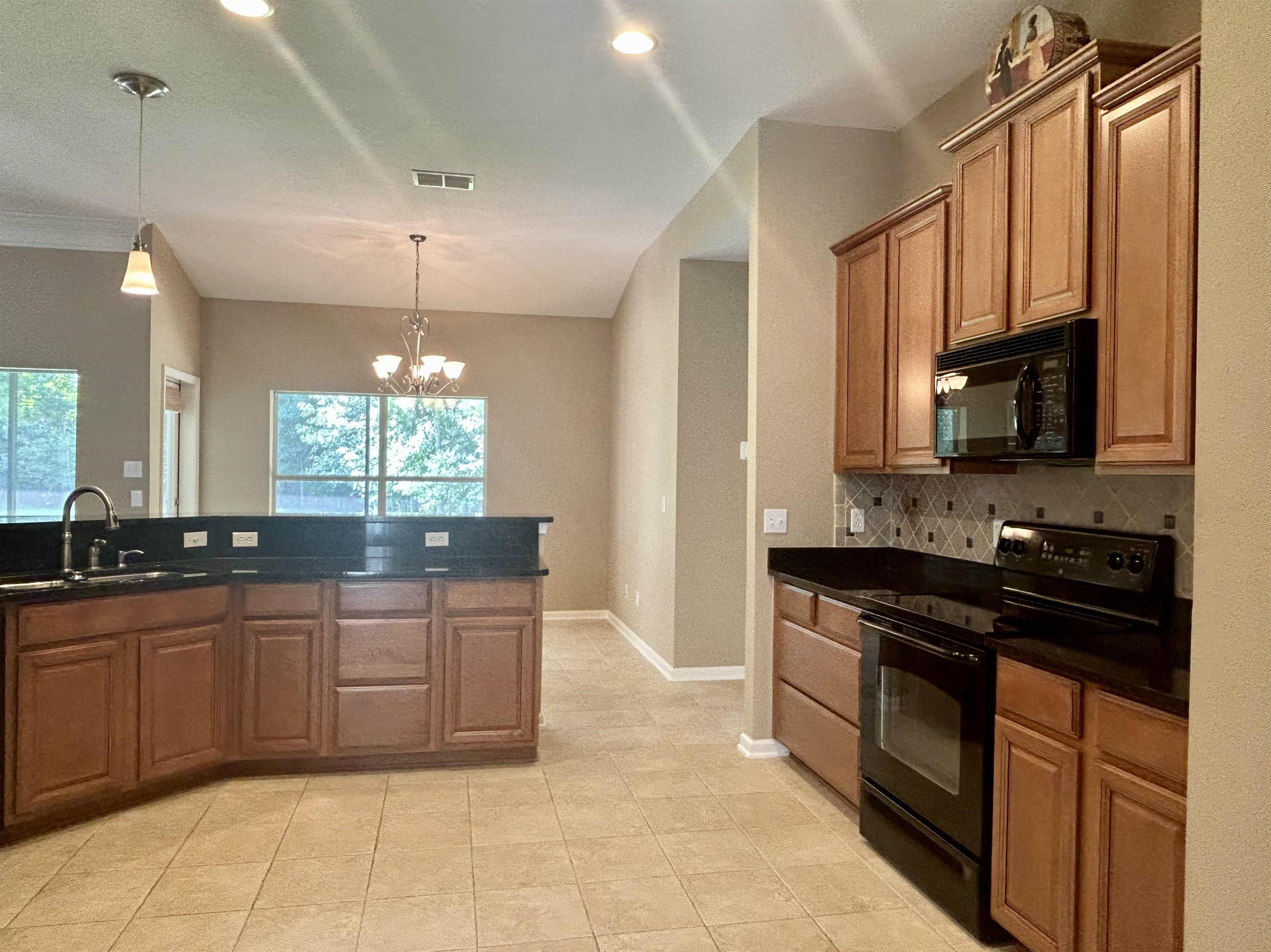 3844 Paddington Place St. Augustine, FL 32092 - Photo 7 of 40 a large kitchen with stainless steel appliances a stove sink and cabinets