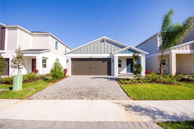 a front view of a house with a yard and garage