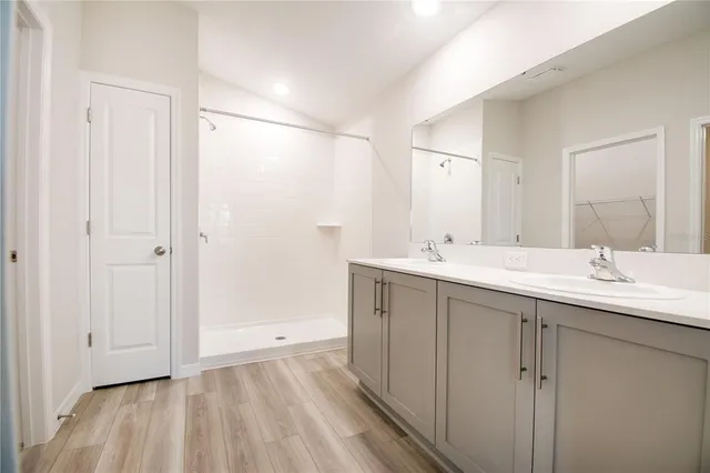 a bathroom with a double vanity sink and mirror