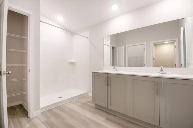 a bathroom with a double vanity sink and a mirror