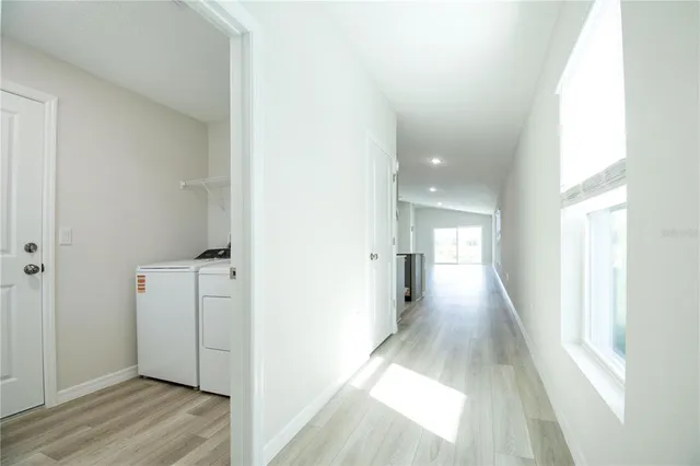 a view of a hallway with wooden floor