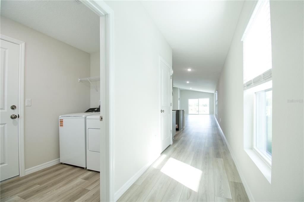 37056 Sagemoor Drive Zephyrhills, FL 33540 - Photo 4 of 21 a view of a hallway with wooden floor