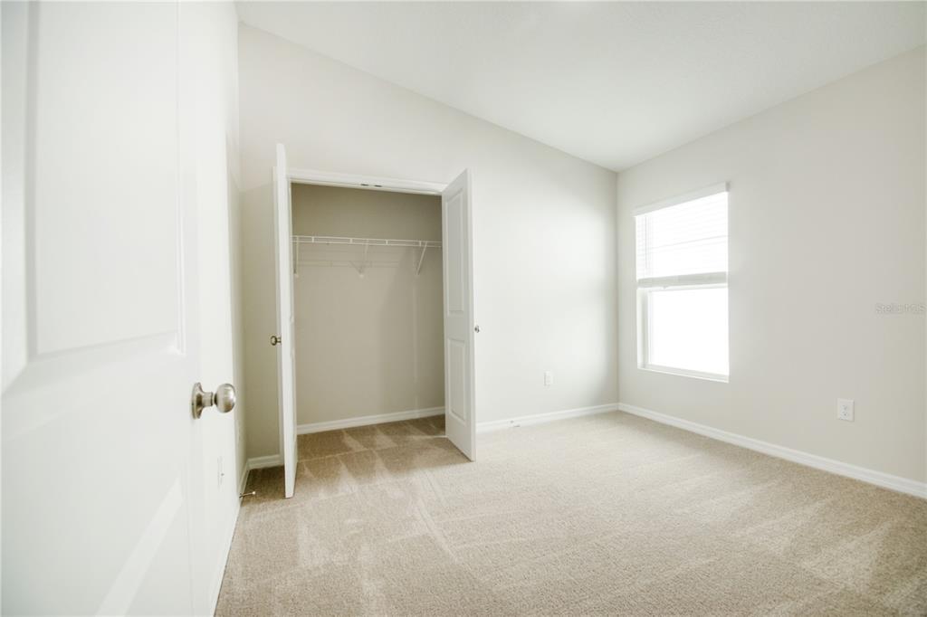 37056 Sagemoor Drive Zephyrhills, FL 33540 - Photo 7 of 21 an empty room with windows