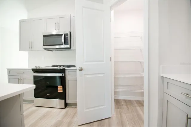 a kitchen with a microwave and a stove