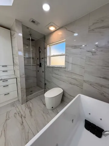 a bathroom with a bathtub and shower