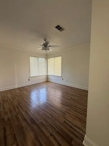 wooden floor in an empty room with a window