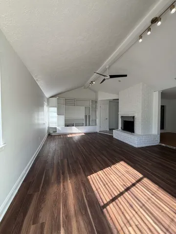 a kitchen with stainless steel appliances granite countertop a sink a stove and a refrigerator
