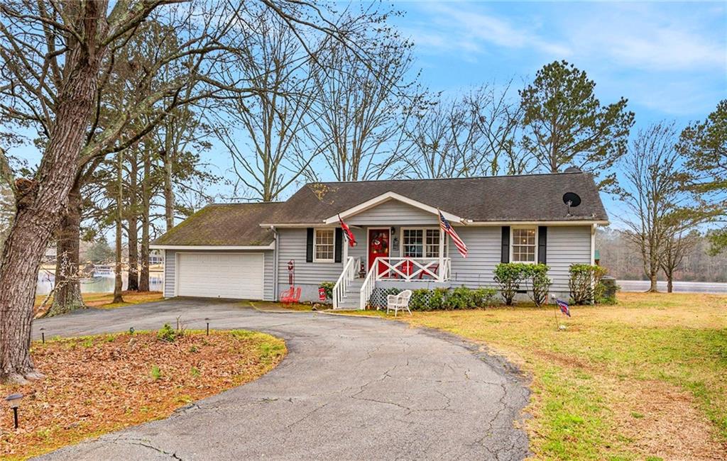 1120 Fisher Way Buckhead, GA 30625 - Photo 1 of 30 a front view of a house with a yard covered with snow
