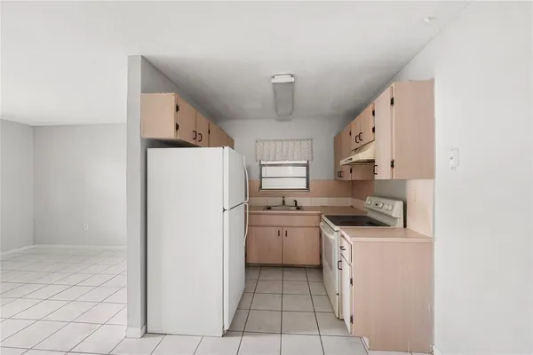 a kitchen with stainless steel appliances a refrigerator sink and stove