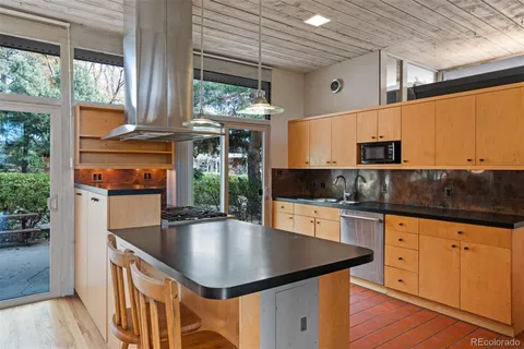 a open kitchen with stainless steel appliances granite countertop a stove and refrigerator