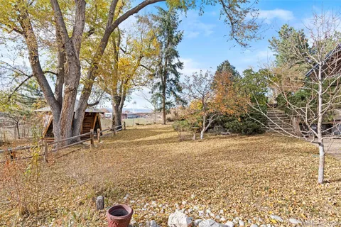 a backyard of a house with yard and outdoor seating