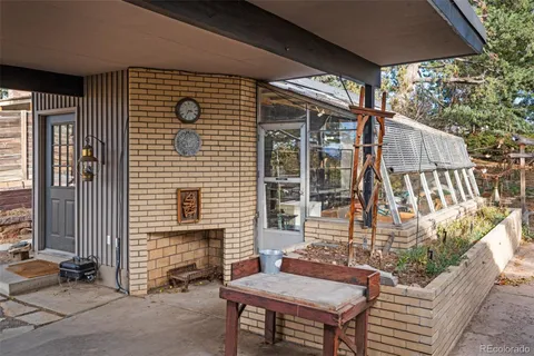 a front view of a house with a tree