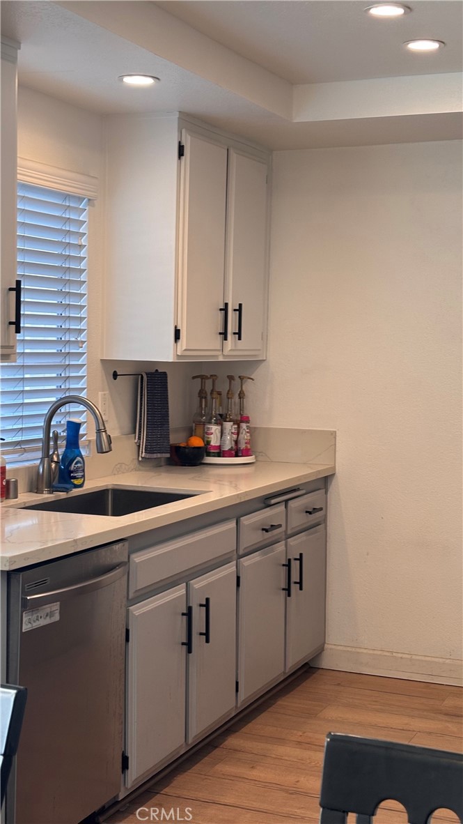103 West Spring Street, Unit A Long Beach, CA 90806 - Photo 11 of 27 a kitchen with stainless steel appliances granite countertop a sink a stove and cabinets