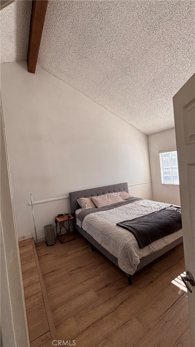 103 West Spring Street, Unit A Long Beach, CA 90806 - Photo 15 of 27 a bedroom with a bed and a flat screen tv