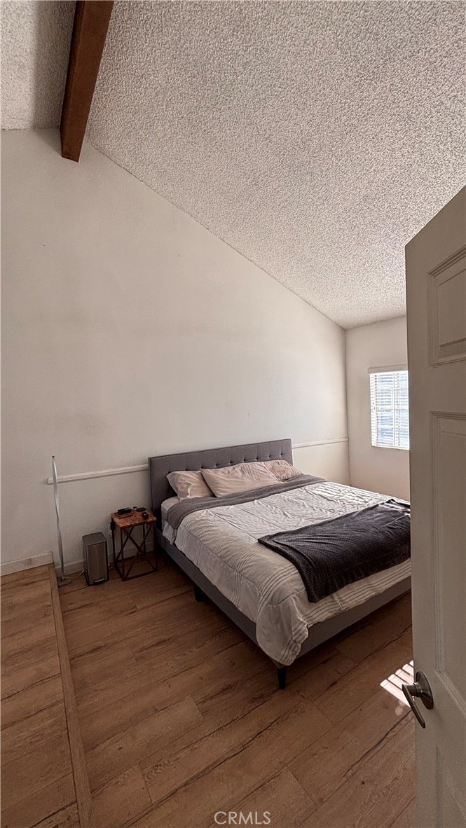 103 West Spring Street, Unit A Long Beach, CA 90806 - Photo 16 of 27 a bedroom with a bed and a window