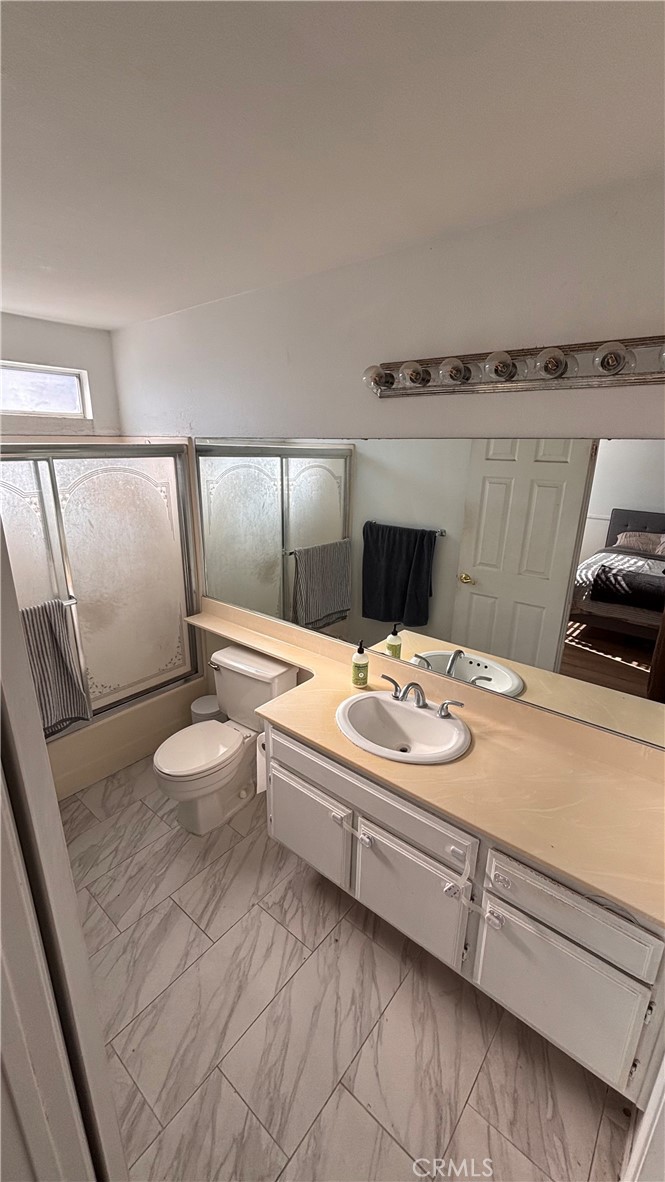 103 West Spring Street, Unit A Long Beach, CA 90806 - Photo 17 of 27 a bathroom with a sink a toilet and mirror