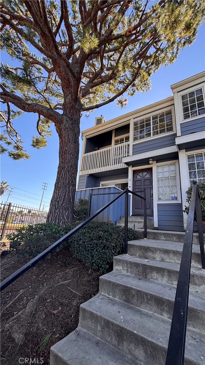 103 West Spring Street, Unit A Long Beach, CA 90806 - Photo 2 of 27 a front view of a house with a yard