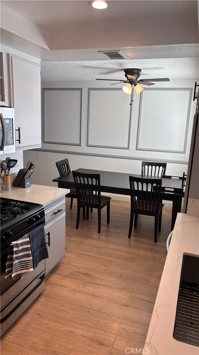 103 West Spring Street, Unit A Long Beach, CA 90806 - Photo 7 of 27 a open kitchen with stainless steel appliances granite countertop a stove and a table