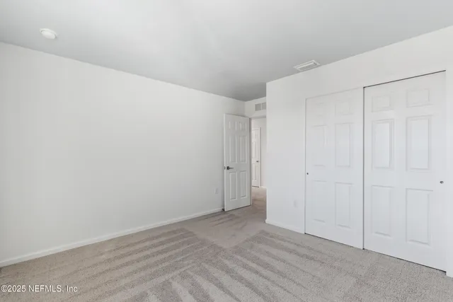 a view of a house with backyard and tree