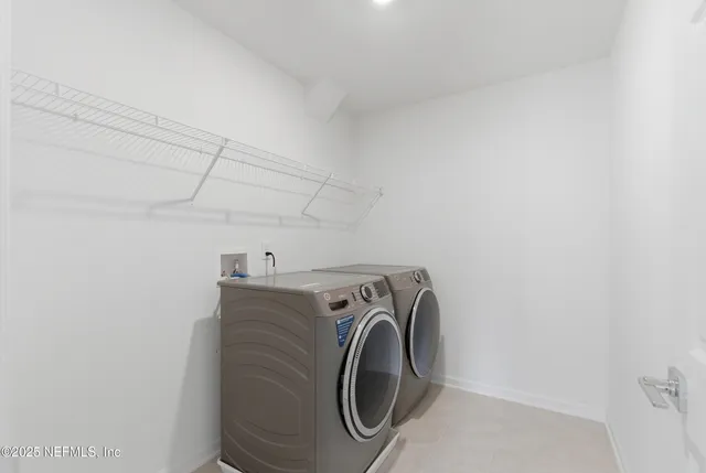 a view of a storage & utility room with two washing machine