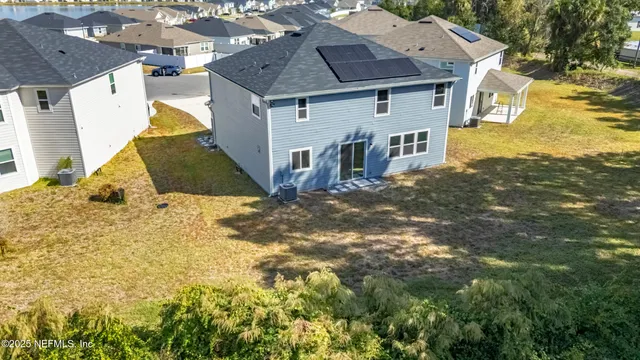 an aerial view of a house with a swimming pool
