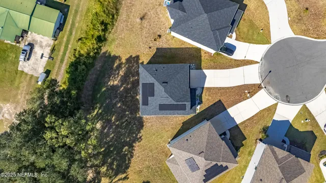 an aerial view of a house with a yard