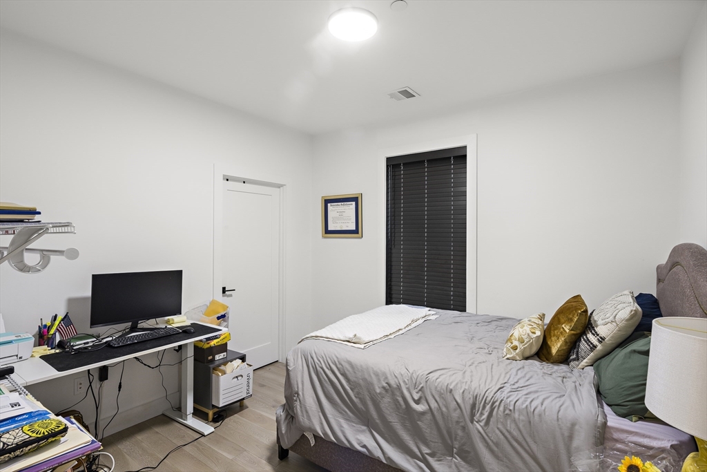 68 Armandine Street, Unit 3 Boston, MA 02124 - Photo 12 of 23 a bedroom with a bed and a flat screen tv