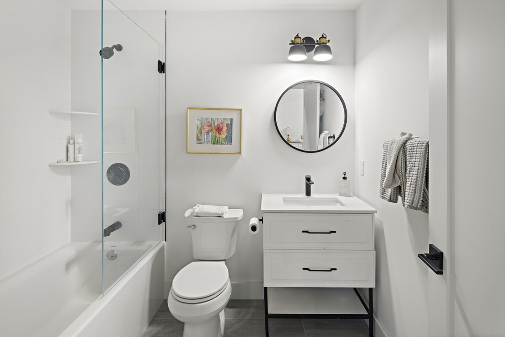 68 Armandine Street, Unit 3 Boston, MA 02124 - Photo 15 of 23 a bathroom with a toilet a sink and a mirror