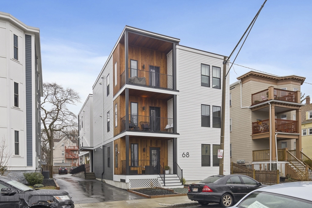 68 Armandine Street, Unit 3 Boston, MA 02124 - Photo 17 of 23 a front view of a building with lot of cars and trees