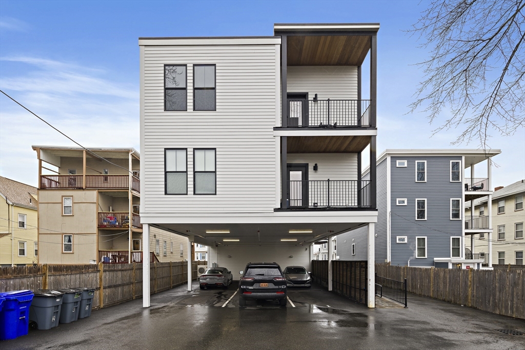 68 Armandine Street, Unit 3 Boston, MA 02124 - Photo 18 of 23 a building with table and chairs