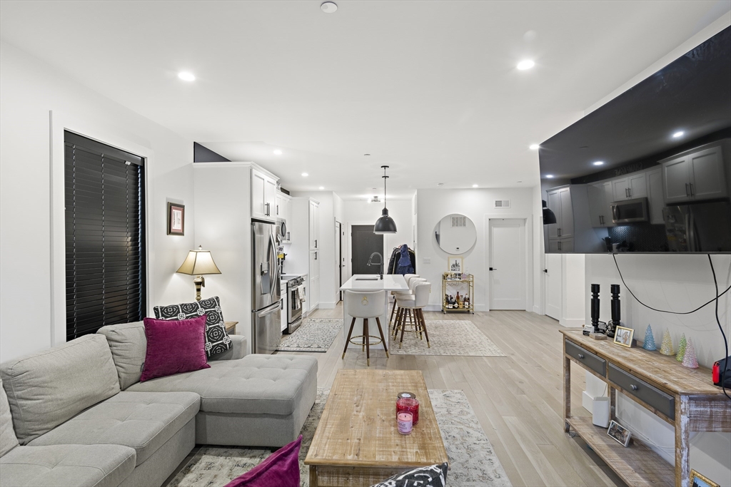 68 Armandine Street, Unit 3 Boston, MA 02124 - Photo 7 of 23 a living room with furniture and a table