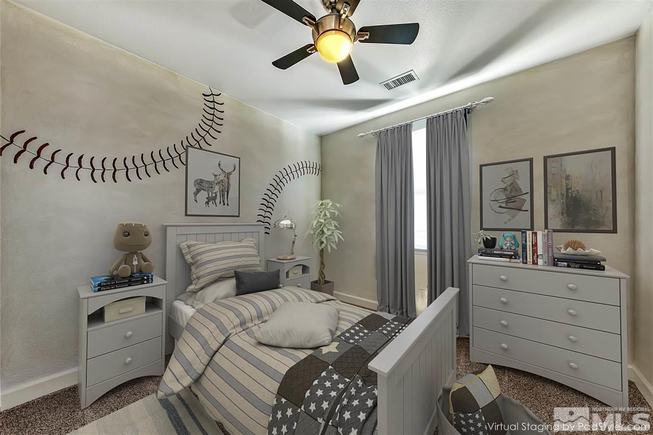 2985 Bull Rider Drive Reno, NV 89521 - Photo 12 of 16 a bedroom with a bed and a chandelier