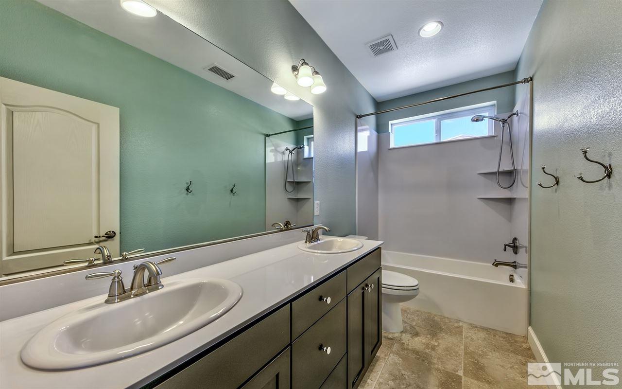2985 Bull Rider Drive Reno, NV 89521 - Photo 13 of 16 a bathroom with a double vanity sink mirror double and bathtub