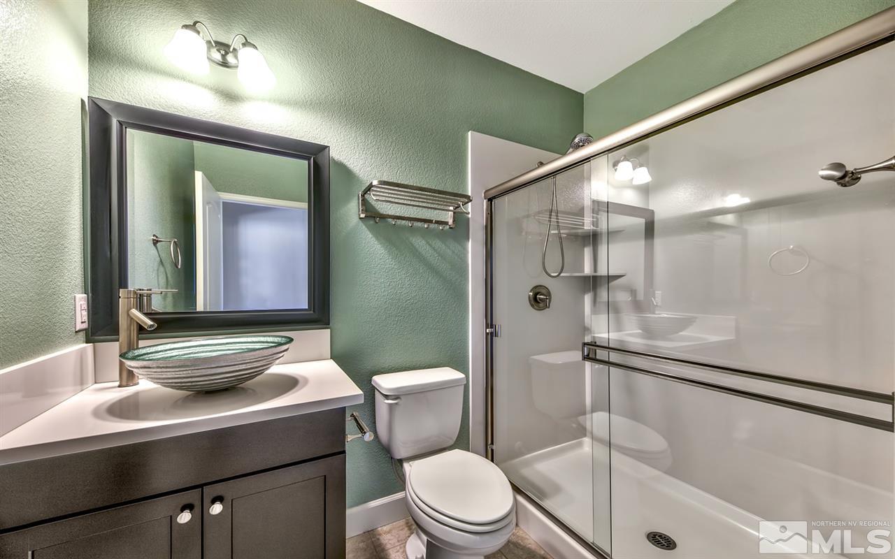 2985 Bull Rider Drive Reno, NV 89521 - Photo 14 of 16 a bathroom with a sink a toilet and shower