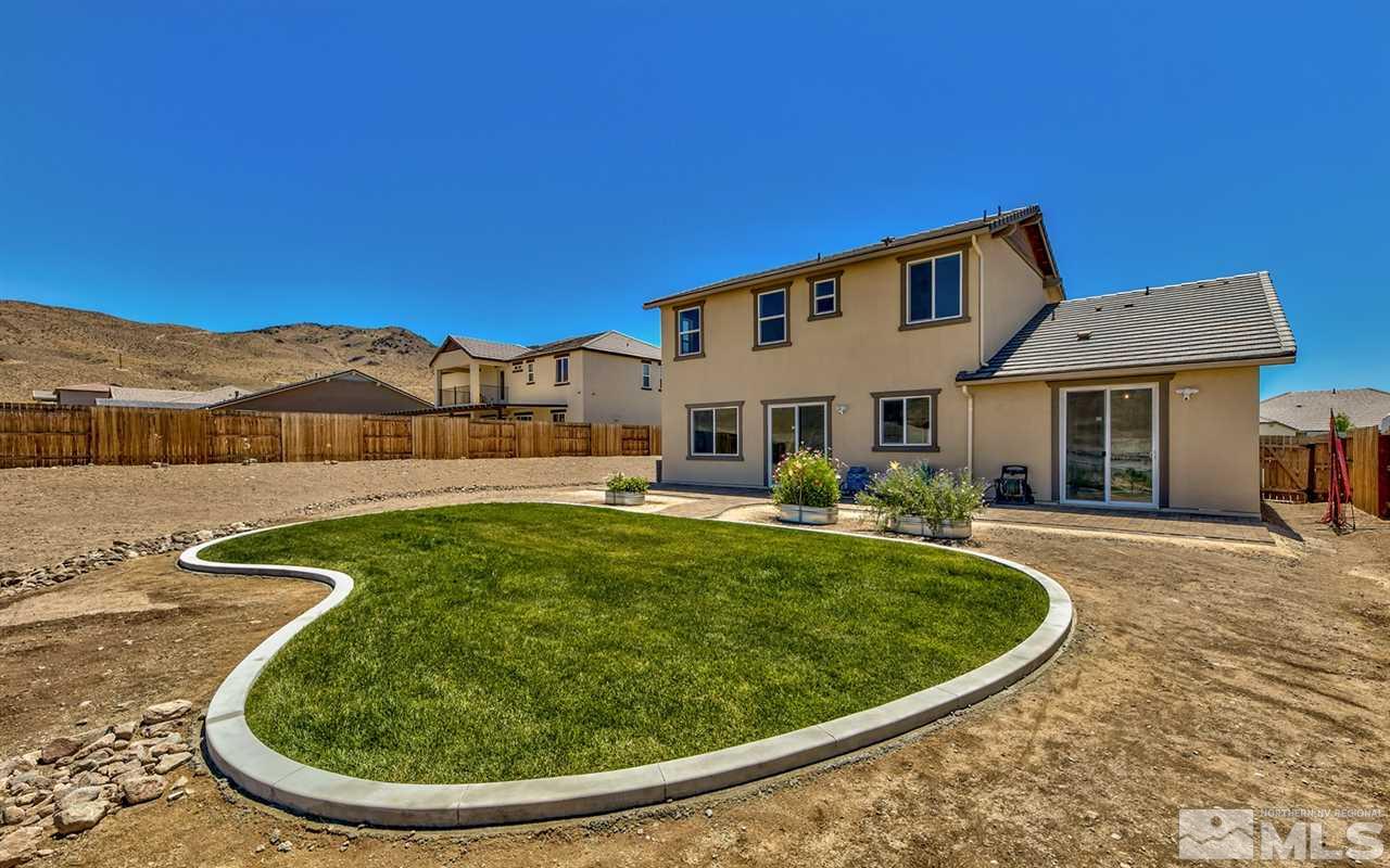 2985 Bull Rider Drive Reno, NV 89521 - Photo 15 of 16 a view of a white house with a swimming pool and a yard