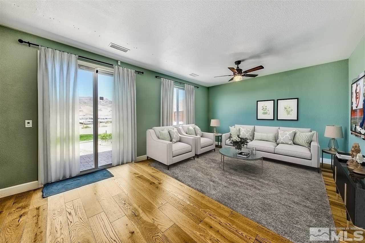 2985 Bull Rider Drive Reno, NV 89521 - Photo 2 of 16 a spacious bedroom with a bed and a couch