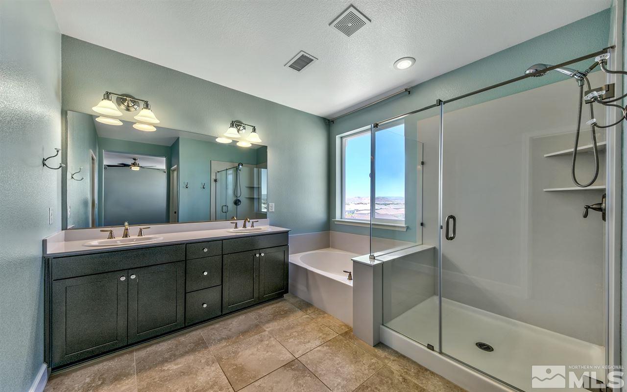 2985 Bull Rider Drive Reno, NV 89521 - Photo 8 of 16 a spacious bathroom with a double vanity sink mirror and shower