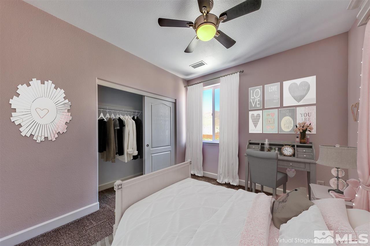 2985 Bull Rider Drive Reno, NV 89521 - Photo 9 of 16 a bedroom with a bed and a chandelier