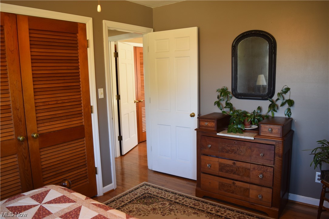 65578 Mathews Road Cambridge, OH 43725 - Photo 17 of 40 Bedroom with a closet and dark hardwood / wood-style flooring